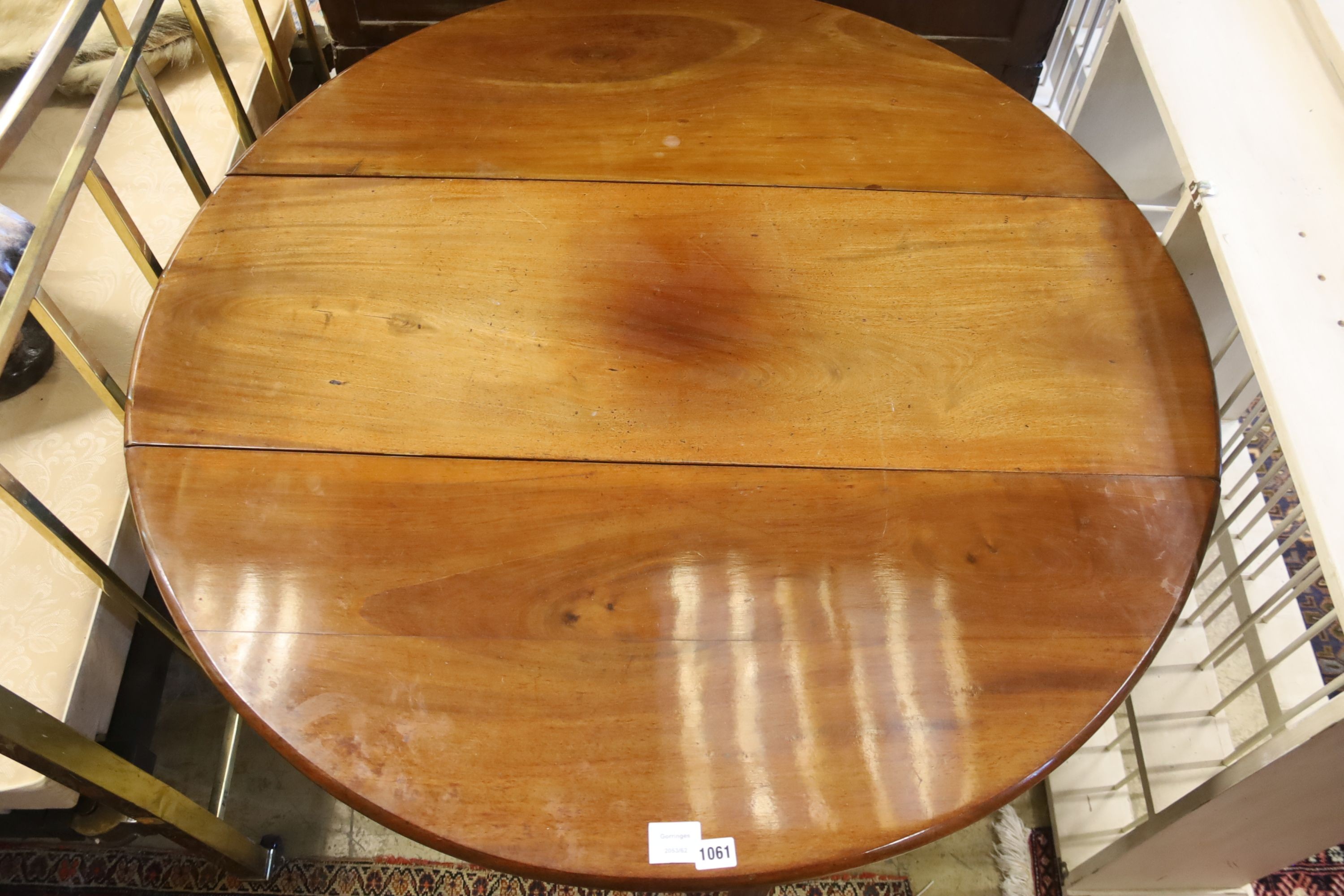 A George III mahogany oval pad foot drop leaf dining table, 116cm extended, 70cm height